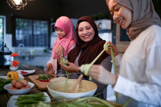 istock Mother and two daughter preparing food 1148922472