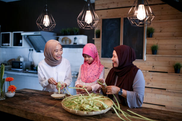 istock Mother and two daughter preparing food 1148922473