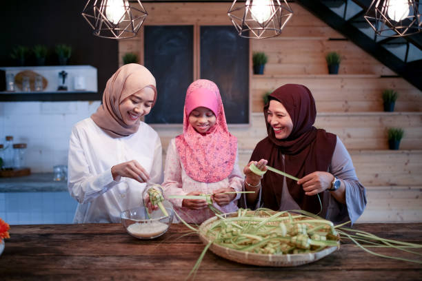 istock Mother and two daughter preparing food 1148922480