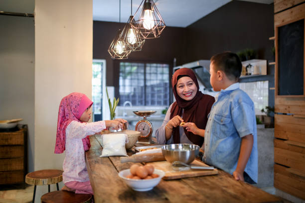 istock Brother and sister assist mother in kitchen 1148922494