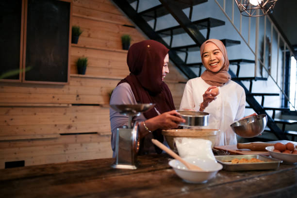 istock Mother and daughter baking in kitchen 1148923548