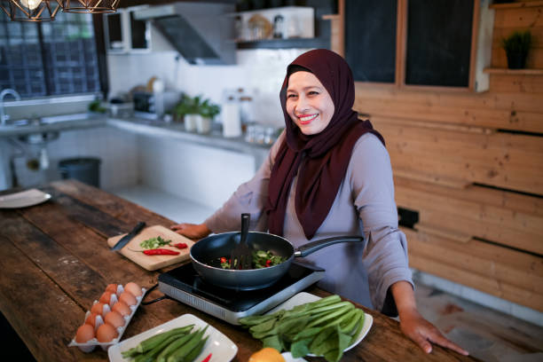 istock One mature women smiling while cooking 1148923633