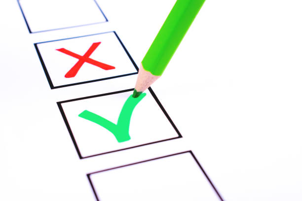 White bulletin with checkboxes and green pencil with red cross and tick drawn as positive and negative selection signs. Elections, choice and approval concept. Copy space for text.