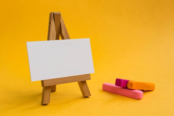 istock Wooden easel on a beautiful colored background. 1148925300