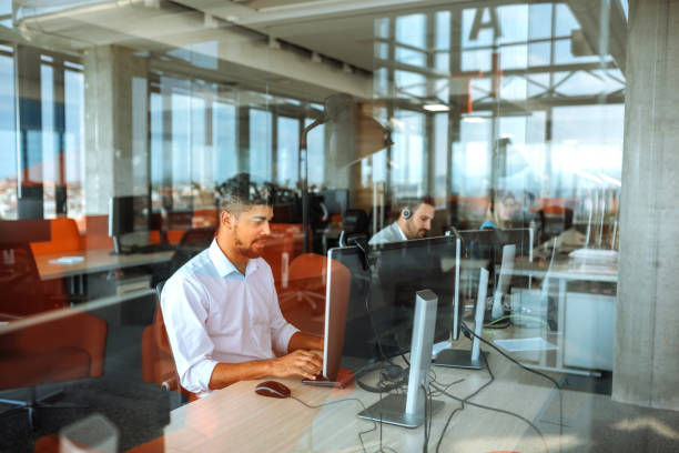 Working in a call centre Team of colleagues working in a call center. prop stock pictures, royalty-free photos & images