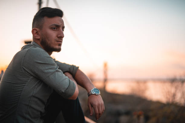 istock Side view of a young handsome man watching sunset 1148928420