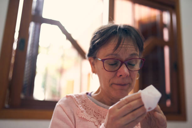 istock Woman sneezing in a tissue 1148929380