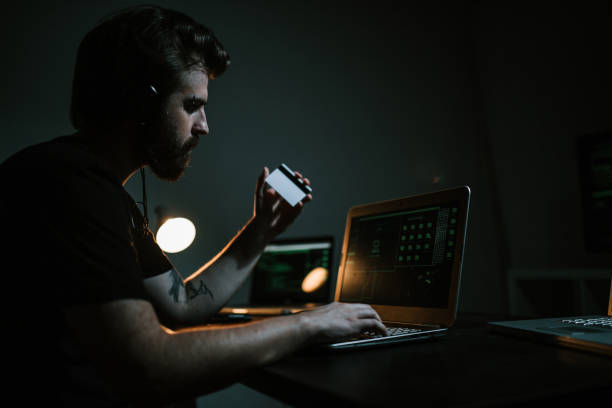 istock Hacker thief stealing money from credit cards 1148930600