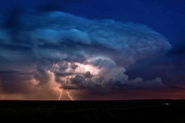 istock Thunderstorm with lightning illuminated cumulonimbus cloud. 1148933440