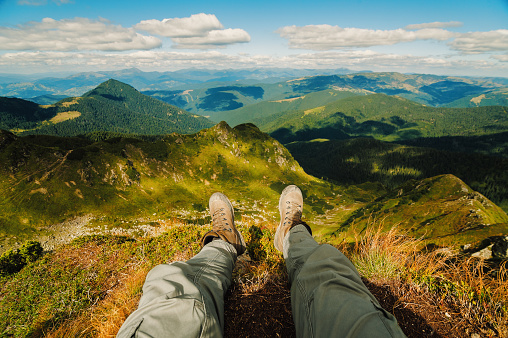Man legs lying down and relaxing in his mountain adventure