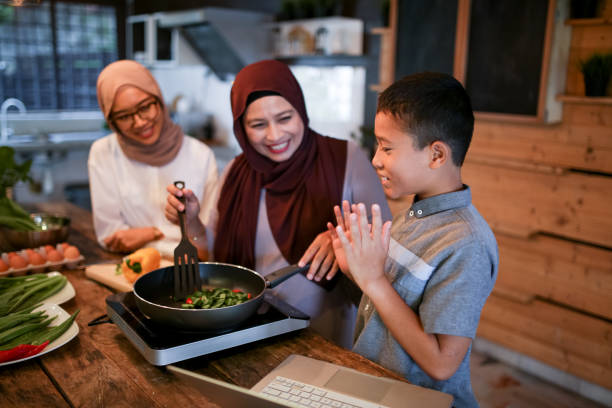 istock Sibling help mother cooking with laptop 1148937499