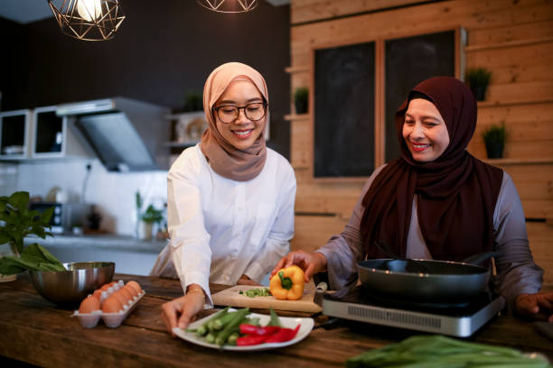 istock Mother and daughter cooking in kitchen 1148937501
