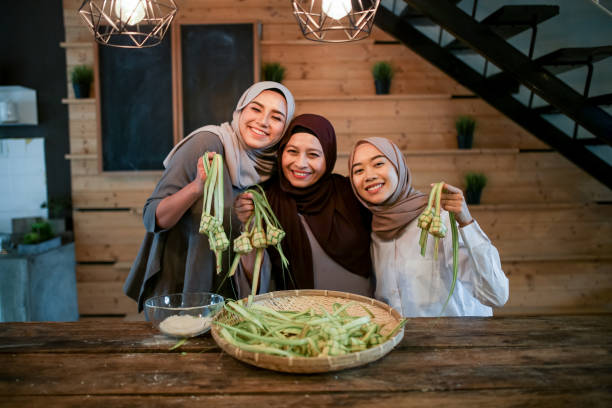 istock Mother with two daughter preparing food in kitchen 1148937557