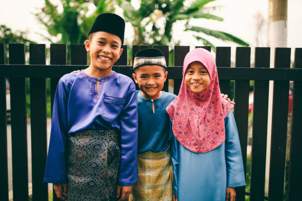 istock Three sibling playing in front of house 1148937591
