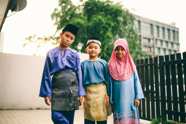 istock Three sibling playing in front of house 1148937594