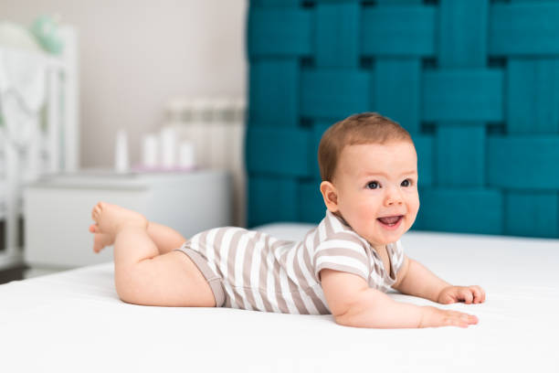 istock Playful baby lying down in bed 1148939267