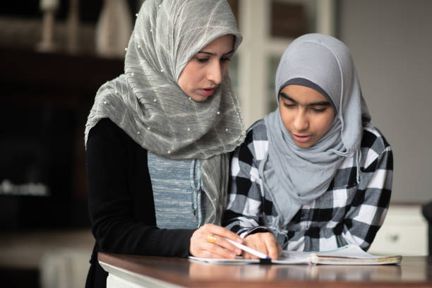 istock Ethnic mother helping her daughter with homework 1148939503