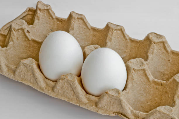 istock Two white eggs in the package for eggs from the chicken farm. Last egg stocks. 1148939952