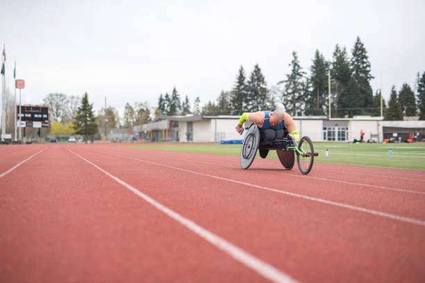 istock Adaptive athlete training on his racing wheelchair on a stadium track 1148940273