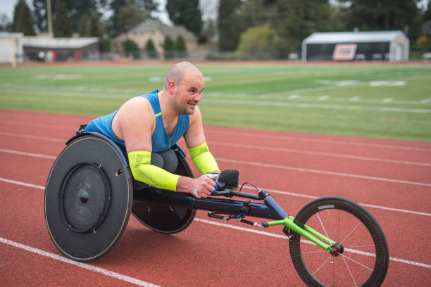 istock Adaptive athlete training on his racing wheelchair on a stadium track 1148940292