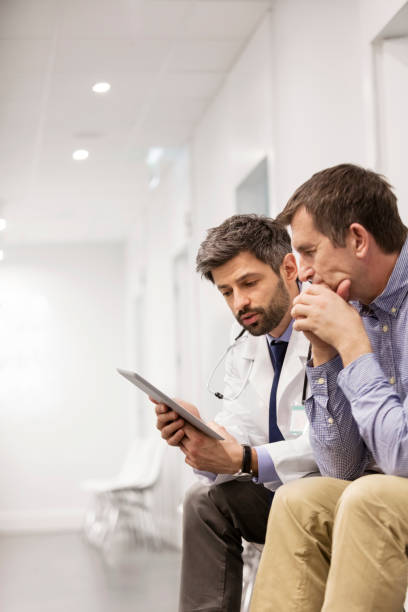 istock Doctor explaining patient over digital tablet at hospital 1148957222