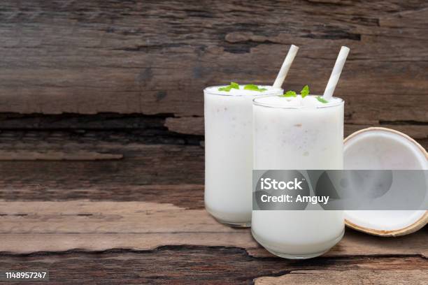 Coconut Smoothies White Fruit Juice Milkshake Blend Beverage Healthy High Protein The Taste Yummy In Glass Drink Episode Morning On A Wooden Background Stock Photo - Download Image Now