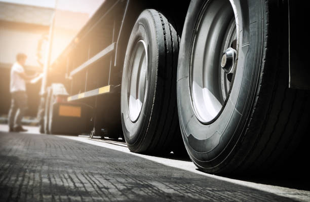 Truck inspecting and safety Close up truck tire and truck driver is checking safety around of semi truck. tire vehicle part photos stock pictures, royalty-free photos & images