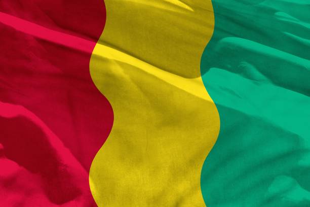 Fluttering Guinea flag for using as texture or background, the flag is waving on the wind