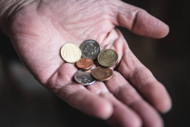 istock coins in the hands of an elderly man 1148973076