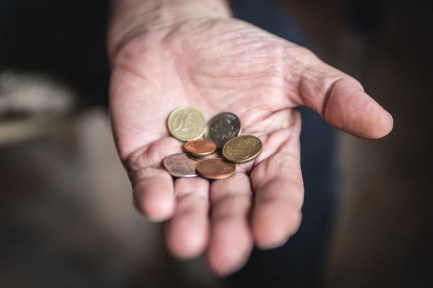 istock Coins in the hands of a pensioner 1148973083
