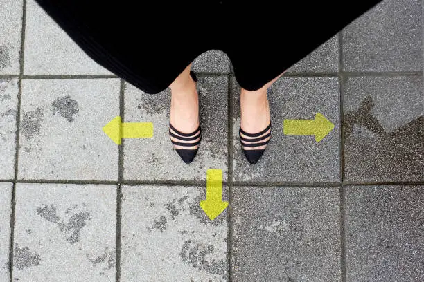 Directional Arrow and Pair of Black Shoes Woman Standing on The Tile Background Great for Any Use.