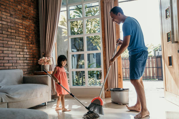 istock father and daughter clean up the house 1148975977