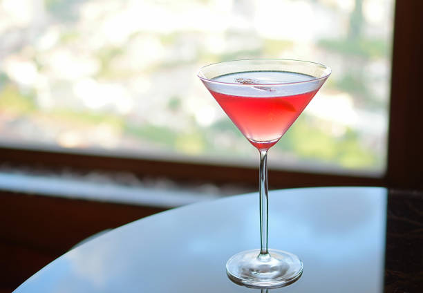 istock Red cocktail on glass table cityscape background daylight 1148976717