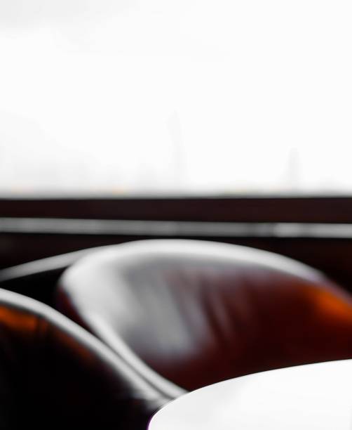 istock Defocused empty seat and glass table near window in hotel restaurant 1148976910