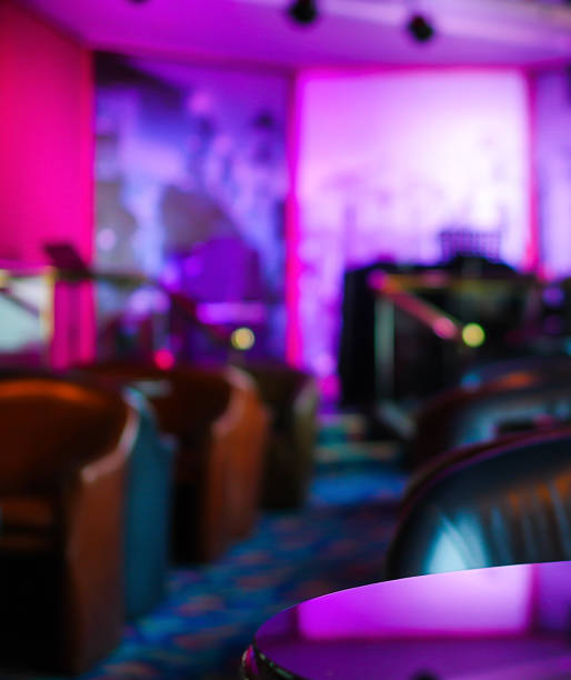 istock Blurred empty bar stage and seat in purple light defocused 1148977635