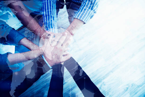 istock Teamwork concept. Business peoples putting their hands together in top view. Stack of hands for unity and team. Success business. 1148978215