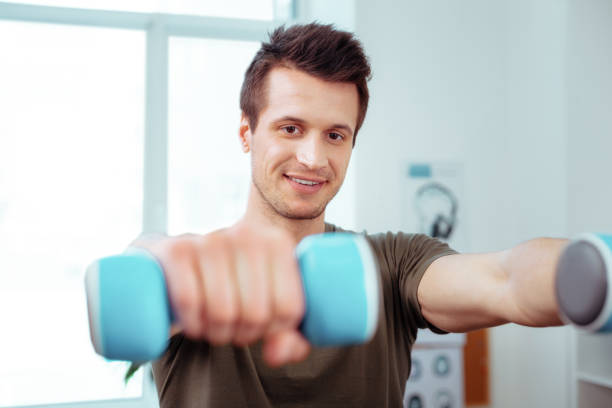 istock Joyful nice man having a morning gymnastics 1148979058