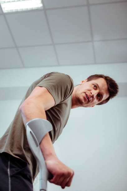 istock Low angle of a handsome young man using crutches 1148979060