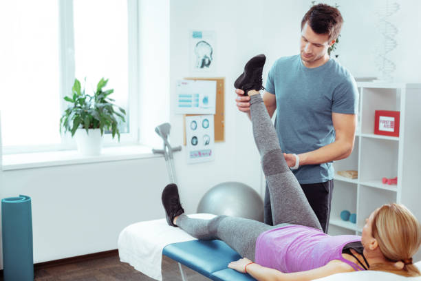 istock Handsome young man holding his patients leg 1148979112
