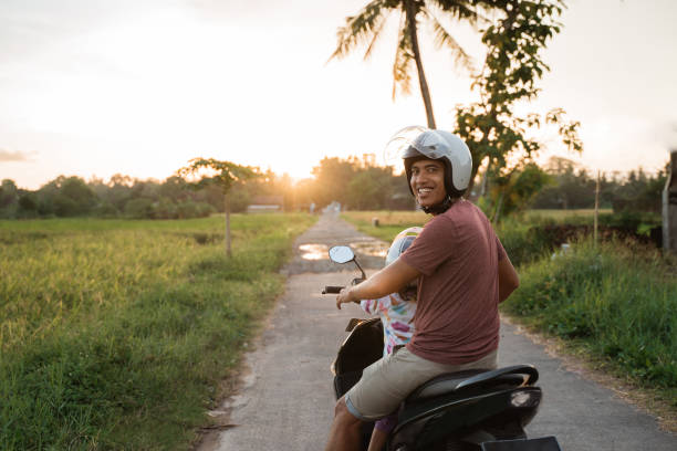 istock asian father and child  ride motorcycle scooter 1148979131