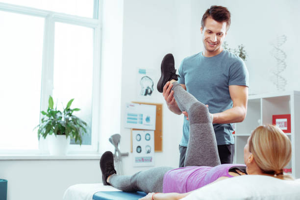 istock Joyful positive man moving his patients leg 1148979134
