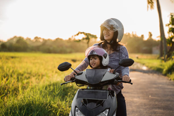 istock mom and child enjoy riding motorcycle scooter 1148979407