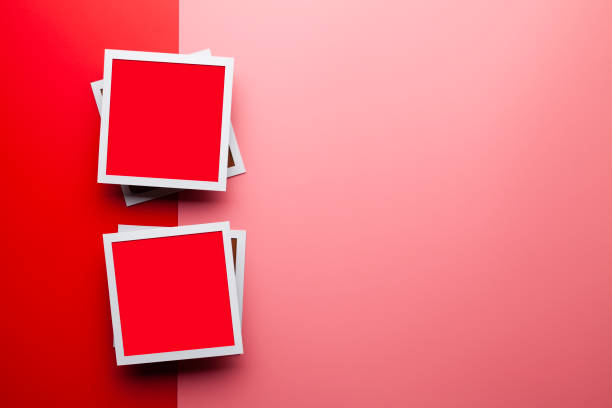 Two white and red photo frames on red and pink background stock photo