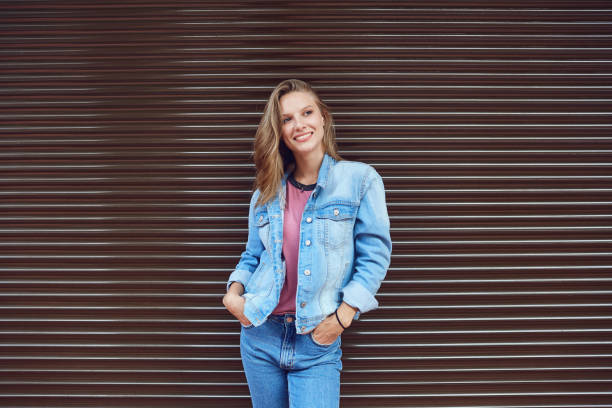 istock Blonde girl smiling on a striped  background .. 1148980144