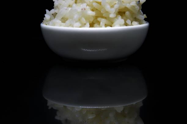 Rice on the white plate with dark background.