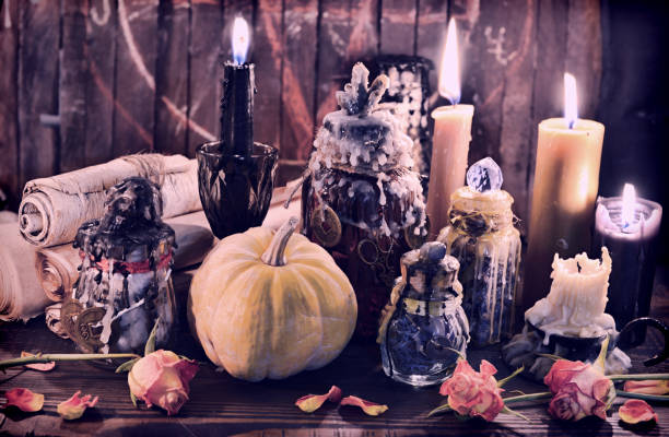 istock Witch bottles with pumpkin, black candles and paper scrolls. 1148982411