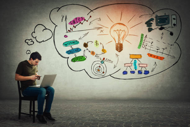 istock Freelancer sitting on chair using his laptop and mobile phone making different calculations and planning future 1148985964
