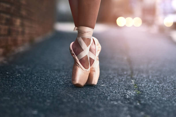 The heart of a dancer lies at her feet Cropped shot of a ballet dancer standing on tiptoes against an urban background ballet shoe stock pictures, royalty-free photos & images