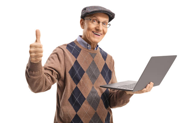 istock Elderly man holding a laptop computer and showing thumbs up 1148986333