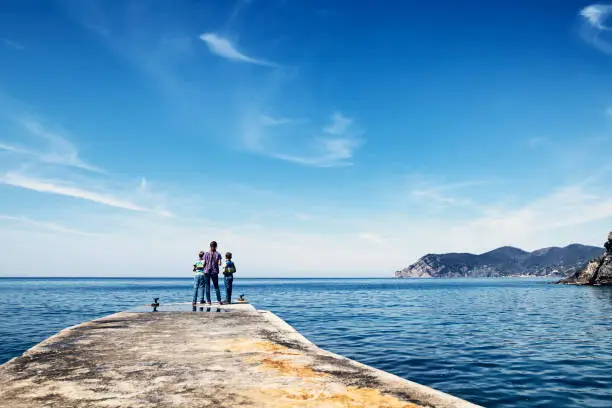 Family sightseeing Corniglia in Cinque Terre National Park - a UNESCO World Heritage Site. Three kids are standing on pier in the old harbour of Corniglia, Cinque Terre, Italy

Nikon D850